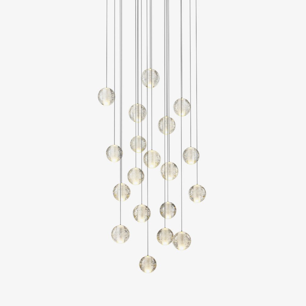 Clérachic crystal ball pendant light with clear glass spheres on fine cables at staggered heights, on a plain white backdrop.