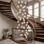 A dense cluster of Clérachic crystal balls glowing down the curve of a wooden staircase with a black rail and arched windows.