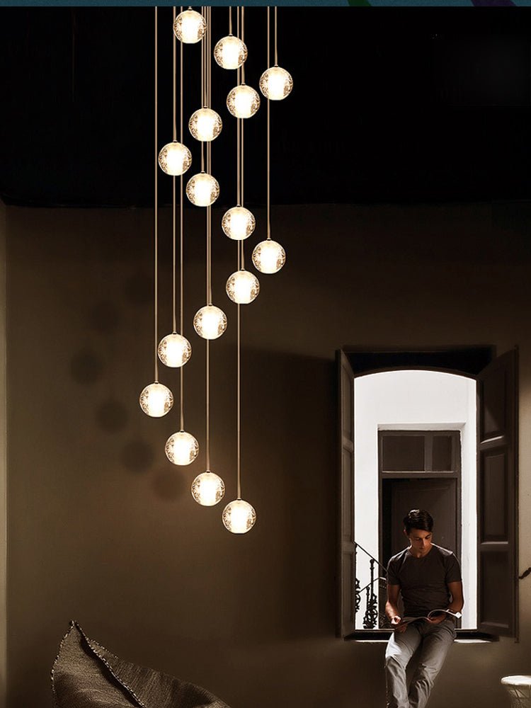 A spiral of Clérachic crystal balls glowing in a dark room, with a person reading on a window seat in the doorway beyond.