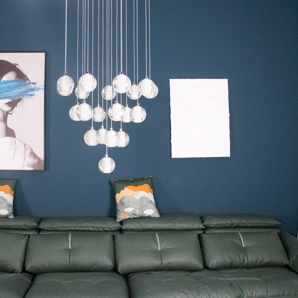Closer view of the unlit Clérachic crystal ball cluster against a teal wall, with a framed print and cushions at the side.
