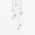Clérachic crystal ball pendants at varied heights on thin cables, shown unlit on a plain white backdrop.
