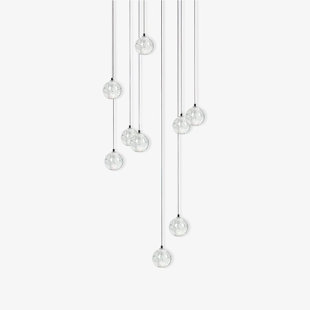Clérachic crystal ball pendants in a group of clear spheres at staggered heights on thin cables, on white.