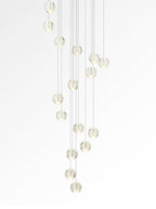 A narrow spiral of Clérachic crystal balls shown against white, glowing softly at different heights.