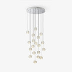 Clérachic crystal ball cluster hung from a round chrome ceiling plate, with the clear spheres at staggered heights, on white.