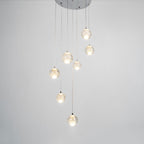 The Clérachic crystal ball pendants lit warm on grey, shown from a slightly different angle below the chrome ceiling plate.