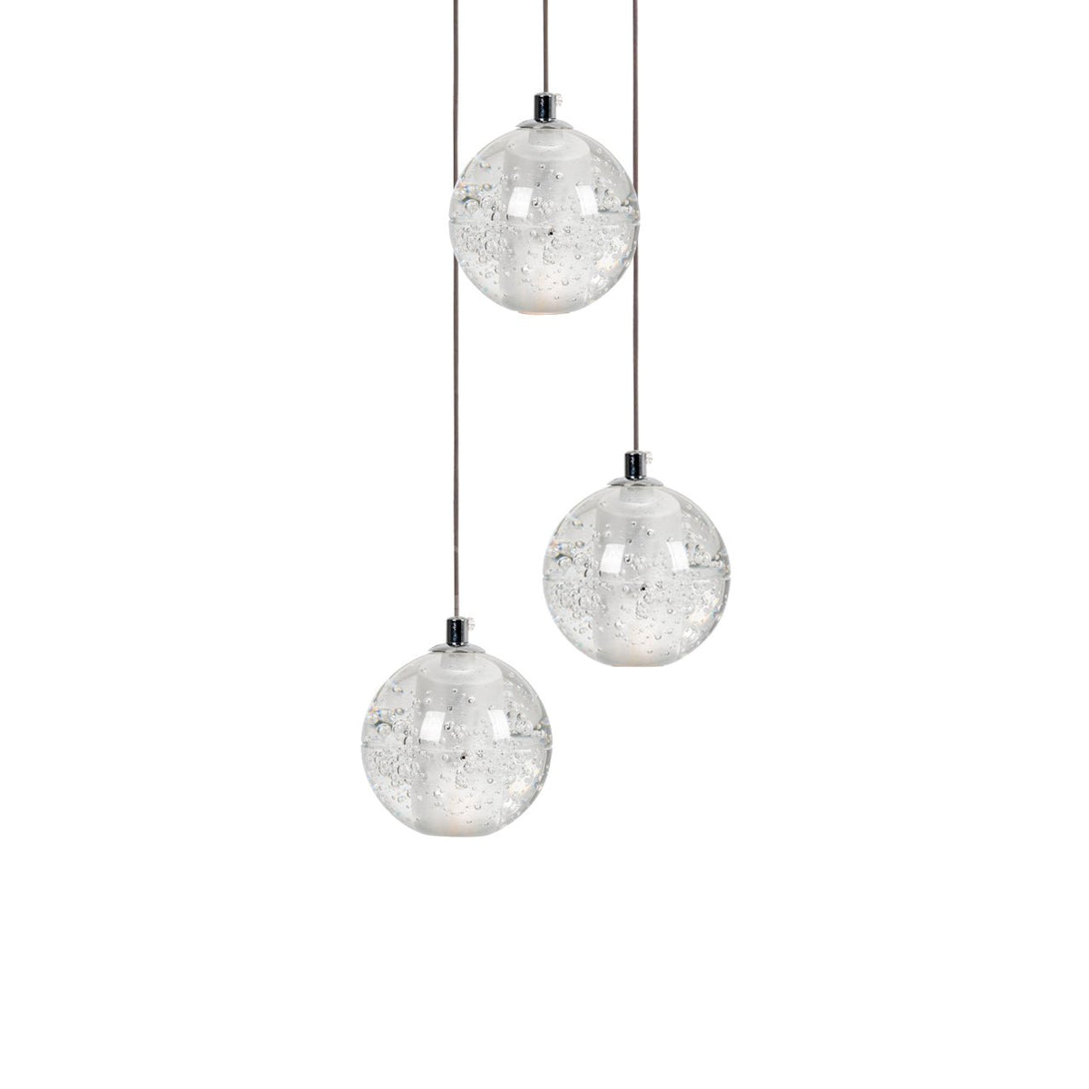 Three Clérachic crystal ball pendants at different heights on thin cables, with trapped bubbles visible in each clear glass sphere.