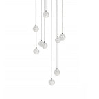 A loose group of Clérachic crystal ball pendants on thin cables of different lengths, hanging on a plain white backdrop.