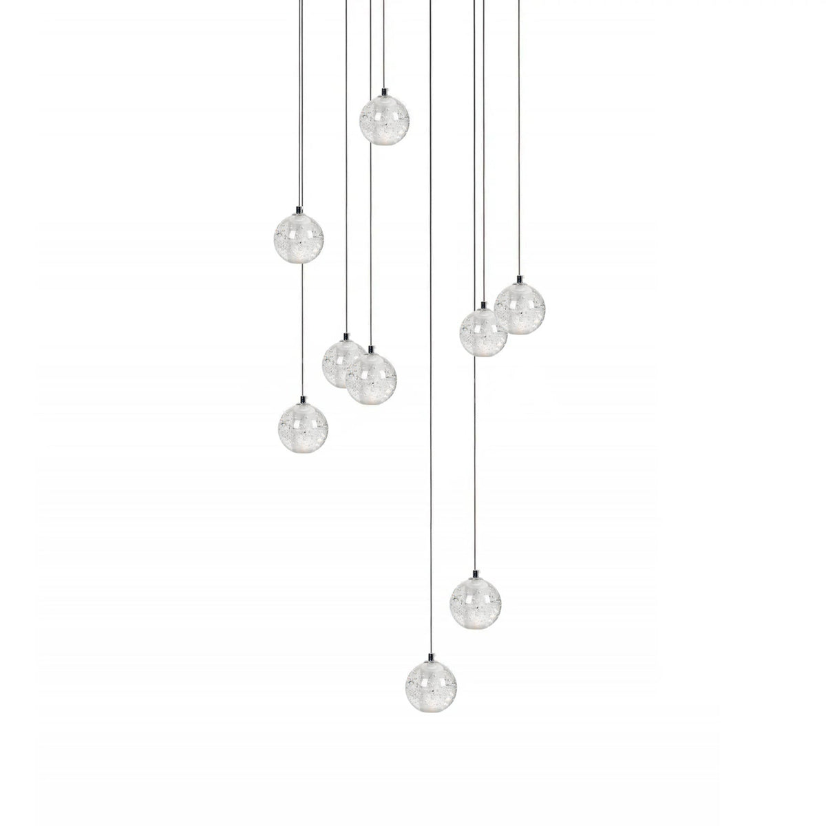 A loose group of Clérachic crystal ball pendants on thin cables of different lengths, hanging on a plain white backdrop.