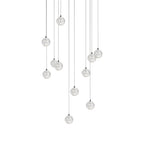 Clérachic crystal ball pendants in a wider spread, the clear spheres on cables of varied lengths, on white.
