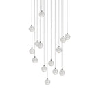 A fuller arrangement of Clérachic crystal ball pendants, with clear spheres on cables of many different lengths, on white.