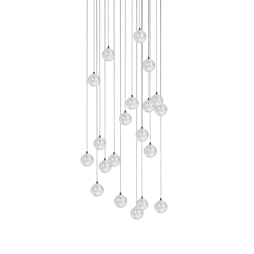 A long arrangement of Clérachic crystal ball pendants, the spheres spread over a deep drop on thin cables, on white.