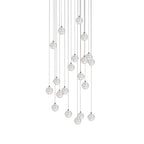 A long arrangement of Clérachic crystal ball pendants, the spheres spread over a deep drop on thin cables, on white.