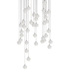 A broad cluster of Clérachic crystal ball pendants with the spheres overlapping at several heights on thin cables, on white.