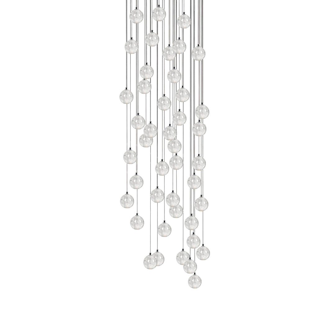 A full-height cluster of Clérachic crystal ball pendants, the clear spheres packed along thin cables, on white.