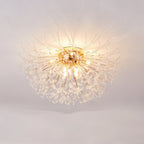 Clérachic gold crystal flush ceiling light on a pale ceiling, a full burst of fine rods with clear crystal beads, lit warm.