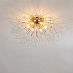 Clérachic gold crystal flush ceiling light with brass-toned arms and bare bulbs, seen from below on a pale ceiling.