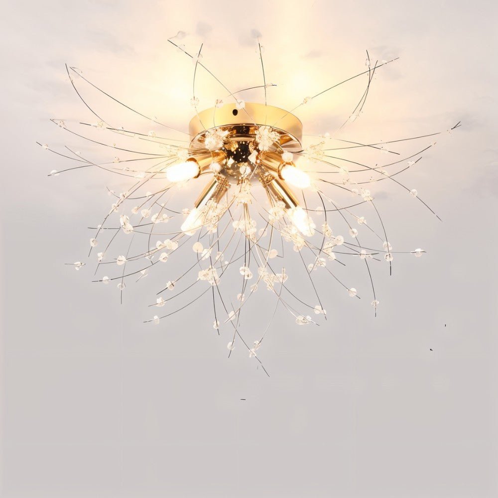 Clérachic four-head gold crystal flush ceiling light with a round gold canopy and sparse beaded rods, lit warm.