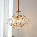 Amber and clear crystals catch the light on this Clérachic chandelier, hung beside sheer white curtains on a fabric-wrapped cord.