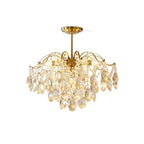 Second white-backdrop view of this Clérachic chandelier, with its amber and clear crystals hanging in tiers from a gold stem.