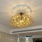 Amber crystal chandelier from Clérachic lit under a decorative white ceiling rose, with an air-conditioning vent along the cornice behind.