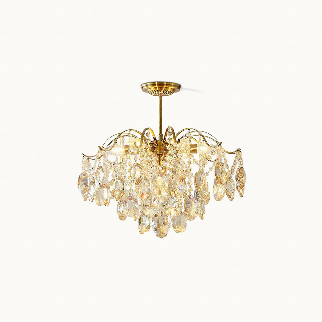 Gold-finished frame with amber and clear teardrop crystals, this Clérachic chandelier shown unlit on a soft white backdrop.