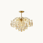 Gold-finished frame with amber and clear teardrop crystals, this Clérachic chandelier shown unlit on a soft white backdrop.