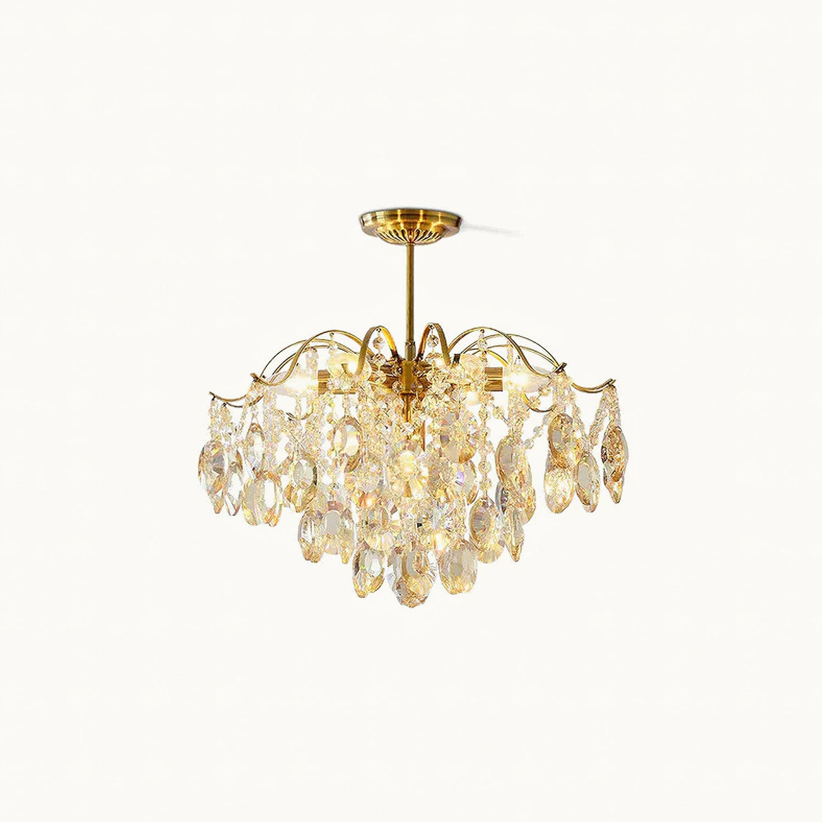 Gold-finished frame with amber and clear teardrop crystals, this Clérachic chandelier shown unlit on a soft white backdrop.