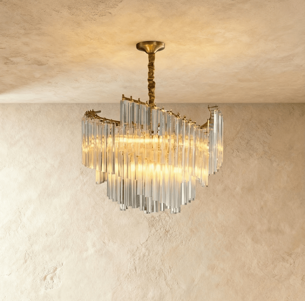 Clérachic crystal-rod chandelier in warm light, its swept tiers of clear glass hanging from a gold canopy and stem.