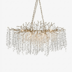 A Clérachic crystal chandelier on a plain white backdrop, with a brass branch frame and many round frosted crystal discs on chains.