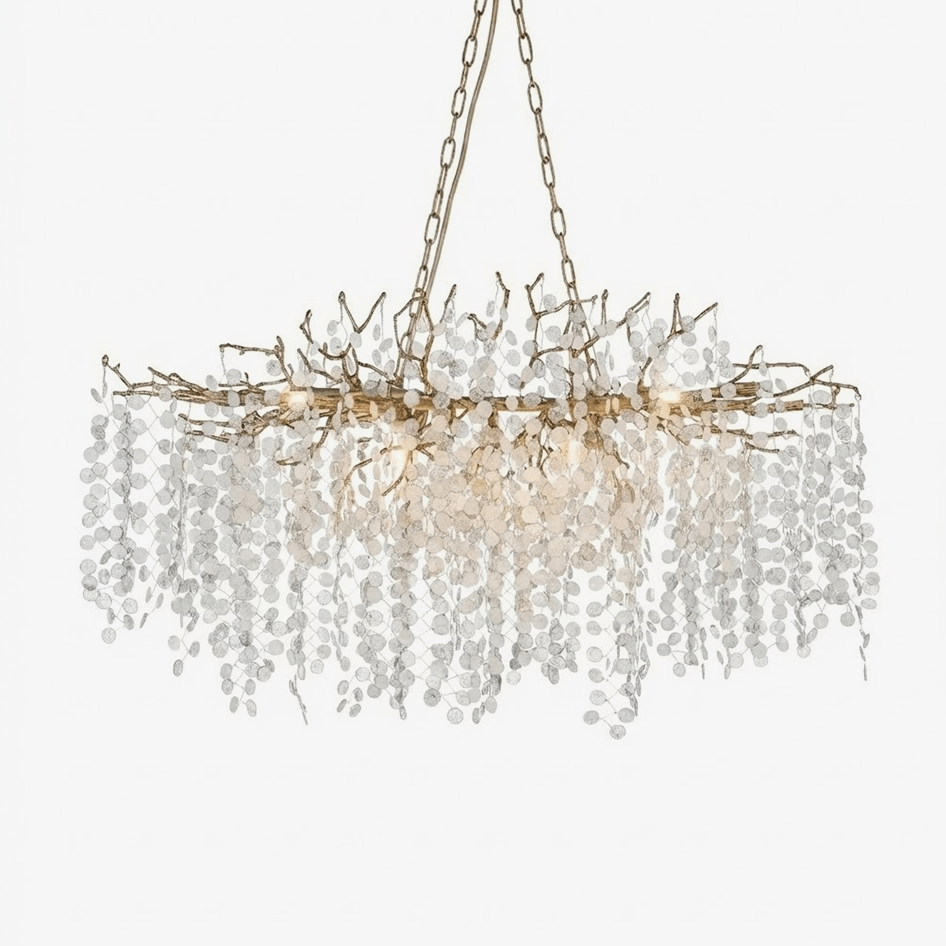 A Clérachic crystal chandelier on a plain white backdrop, with a brass branch frame and many round frosted crystal discs on chains.