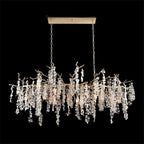 A long Clérachic chandelier on a black backdrop, hung from a rectangular canopy by two chains, its strands at varied lengths.