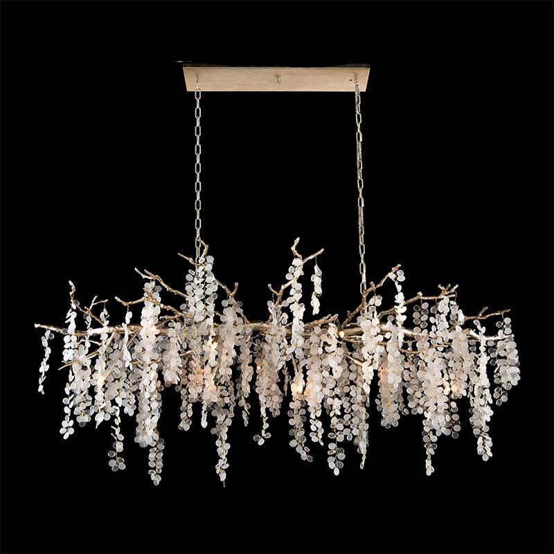 A long Clérachic chandelier on a black backdrop, hung from a rectangular canopy by two chains, its strands at varied lengths.