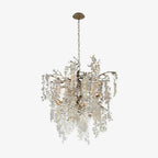 A round, drum-shaped Clérachic chandelier on a plain white backdrop, with silver-toned branches and frosted discs.