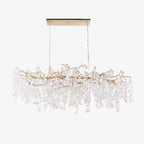 A long Clérachic chandelier on a white backdrop, hung from a slim canopy plate, with the crystal discs a pale frosted white.