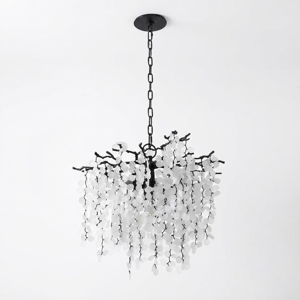 A round Clérachic chandelier in black with a black chain and canopy, on a pale grey backdrop.
