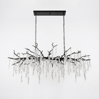 A long Clérachic chandelier in black, hung from a black rectangular canopy, with a black branch frame and clear crystal strands.