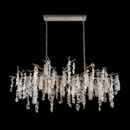A long Clérachic chandelier with silver-toned branches on a black backdrop, hung from a rectangular canopy by two chains.