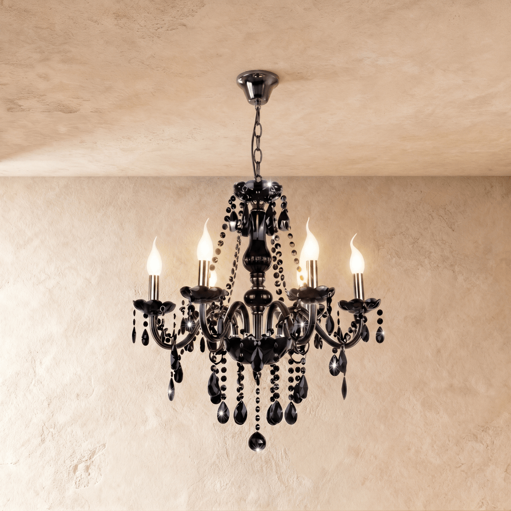 A studio view of the Clérachic chandelier's six black glass arms, lit candle bulbs and beaded crystal chains on show.