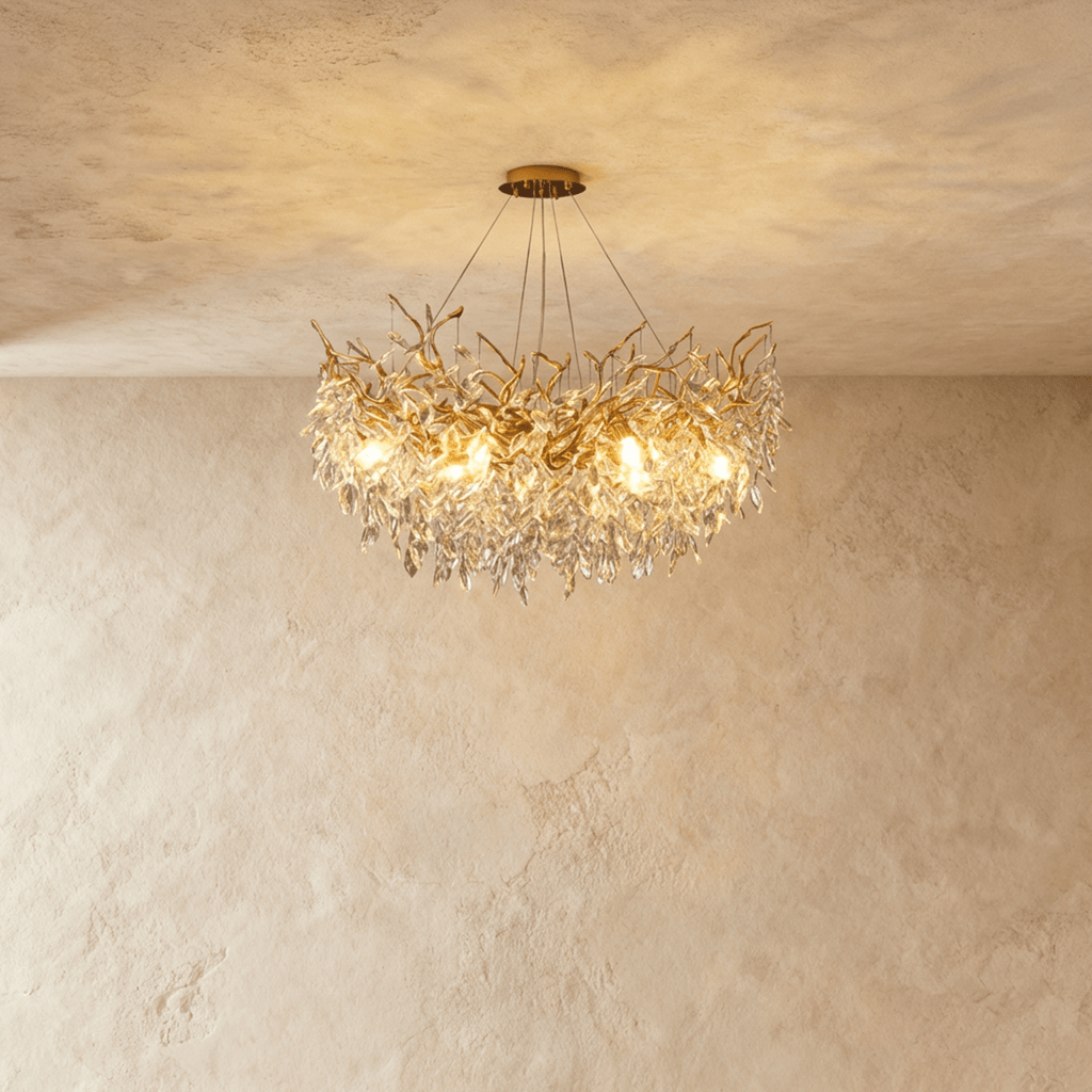 Clérachic gold branch-form crystal chandelier with clustered leaf-cut crystals, hung from a round ceiling canopy.