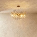 Clérachic gold branch-form crystal chandelier with clustered leaf-cut crystals, hung from a round ceiling canopy.