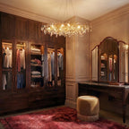 Clérachic crystal chandelier glowing above a dressing table, its gold branches lit warm in a walk-in closet.