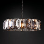 Clérachic black ring chandelier of faceted crystal panes, lit warm and hung from a black chain against a dark backdrop.