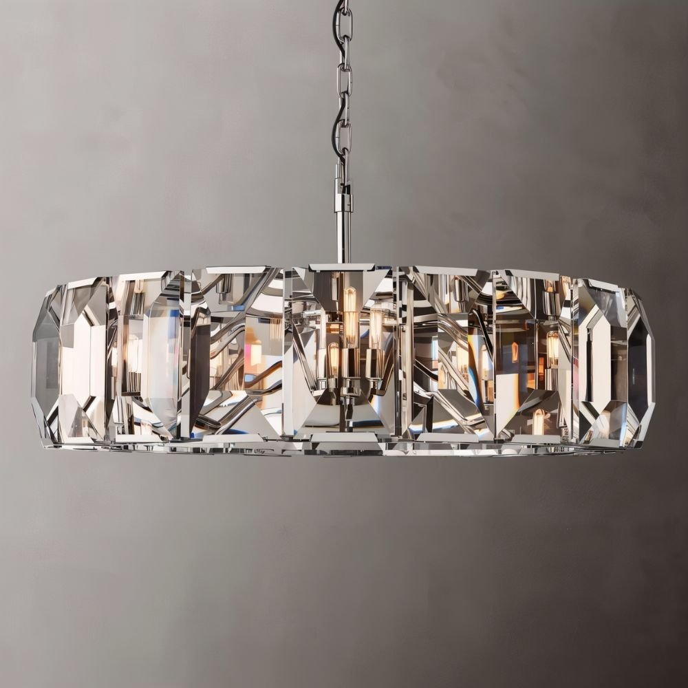 Clérachic large ring chandelier in polished steel with faceted crystal panes and a steel chain, set on a grey backdrop.