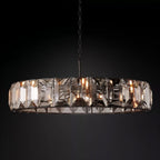 Clérachic blackened-metal ring chandelier with smoky faceted crystal panes and warm bulbs glowing against a black backdrop.