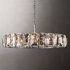 Clérachic polished steel ring chandelier of tall faceted crystal panes, steel chain and rod, shown on a grey backdrop.