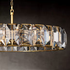 Close crop of the Clérachic brass ring chandelier showing the chain, rod joint and bevelled crystal panes with candle-style bulbs.