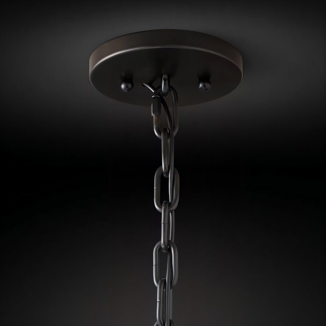 Clérachic matte black ceiling canopy with a chain link and hook, seen from below against a dark backdrop.