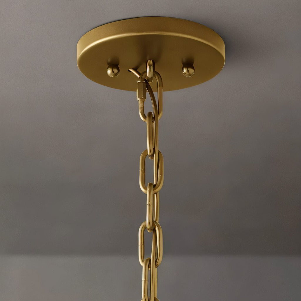 Clérachic brass ceiling canopy with two ball finials and a chain link, seen from below against a grey wall.