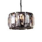 Clérachic compact black drum chandelier with smoky bevelled crystal panes and filament bulbs, on a white background.