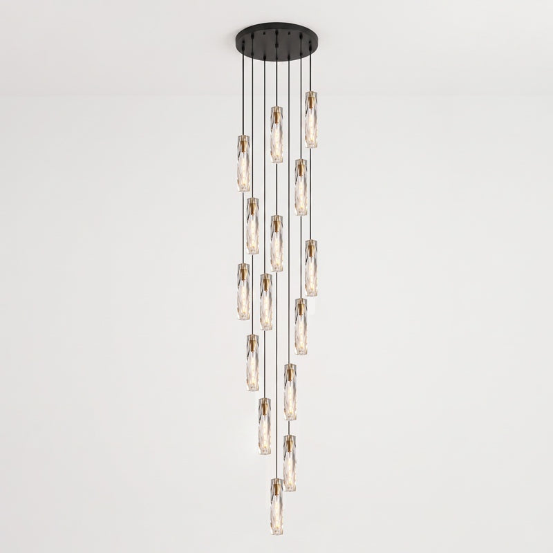 Wide spiral of Clérachic crystal pendants hung at many heights from a large round black ceiling plate, against a pale wall.